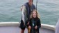 A happy young lady with a big bluefish